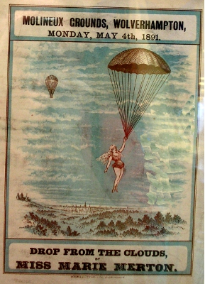 [1891 of a woman droppped from a balloon floating the ground holding a parachute.]